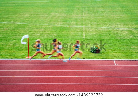 Female runners, blurred sport photo. Original athletics wallpaper for summer olympic Tokyo 2020.