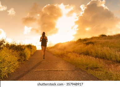 Female running at sunset.  - Powered by Shutterstock