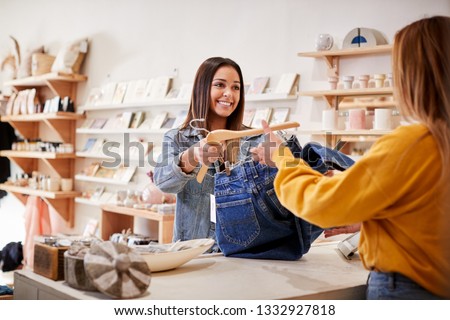 Female Sales Assistant In Independent Clothing And Gift Store Serving Female Customer