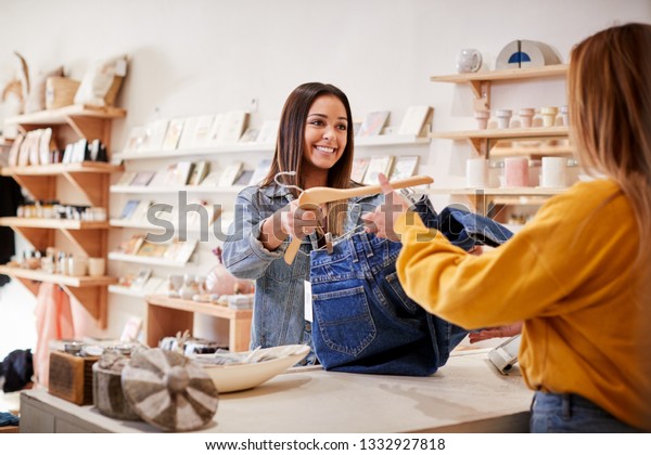 Female Sales Assistant In Independent\
Clothing And Gift Store Serving Female\
Customer