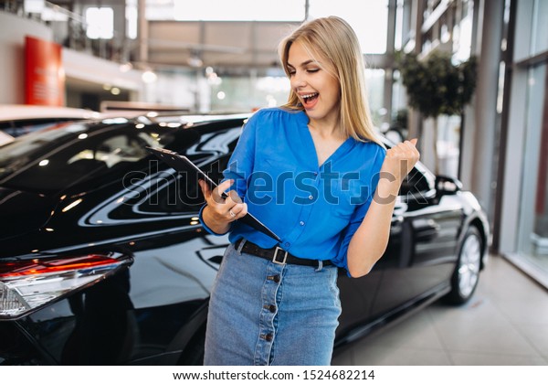 Female sales person in a
car showroom