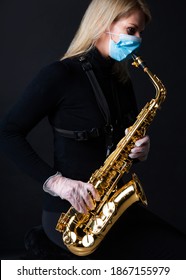 Female Saxophone Player With Facial Mask And Protective Gloves