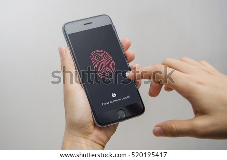 Female scanning fingerprint on smartphone, on gray background. Unlock mobile phone.