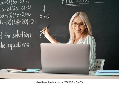 Female School College Math Teacher Teaching Online Remote Virtual Class In Classroom Having Video Call Lesson Talking In Distance Chat Giving Lecture Using Laptop Computer. Distant Education Concept