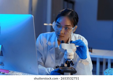 Female scientist analyzing microscope data, conducting advanced biomedical research in sterile laboratory environment