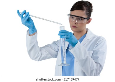 Female Scientist Conducting An Experiment Against White Background