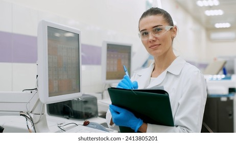 A female scientist controls the operation of devices for laboratory research. Modern laboratory technologies. Medical research centrifuge. - Powered by Shutterstock