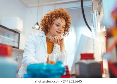 A female scientist examines samples in a laboratory, full of, state of the art research equipment. The NMR apparatus is discovering diseases such as autism, diabetes, dementia and cancer.  - Powered by Shutterstock