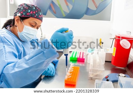 Female scientist extracting DNA using the spin column-based nucleic acid purification technique