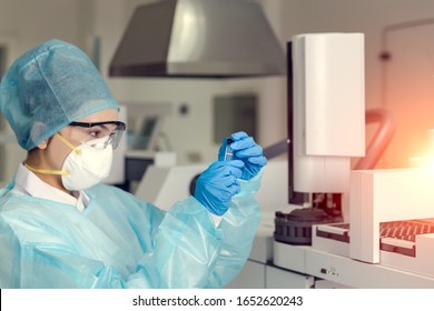 Female scientist looking at the scientific sample in the laboratory.