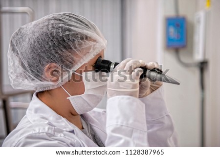 Female scientist looking at the scientific sample in the laboratory