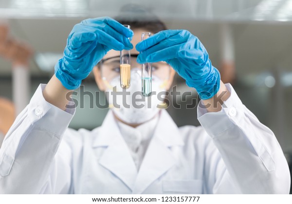 Female scientist looking at the scientific\
sample in the laboratory