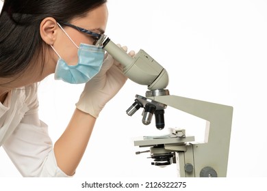 Female Scientist Looking Through A Microscope, Close Up, White Background