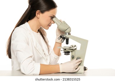 Female Scientist Looking Through A Microscope, White Background