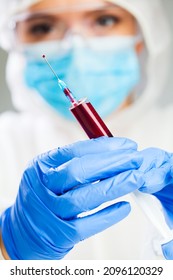 Female Scientist Or Medical Doctor Holding Syringe Full Of Blood,serology Laboratory Testing Procedure,COVID-19 Convalescent Patient Platelet Rich Plasma Transfusion Therapy,immunization Against Virus