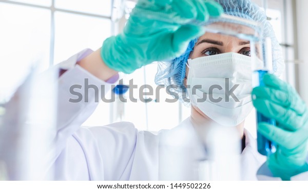 Female Scientist Testing Experiment In A Science Lab Where She Holding Scientific Test Tube Full 2982