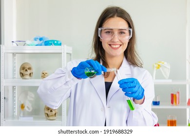 Female Scientist Wearing Blue Safety Glasses And Smiling With Hold Beaker Chemical Isolated With White Background