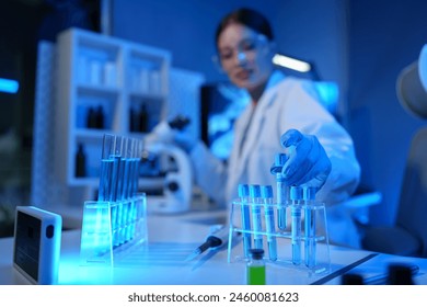 Female scientist working in modern laboratory Doctor doing microbiological research Laboratory tools include microscopes, test tubes, healthcare concepts, medicine, medical experiments. - Powered by Shutterstock