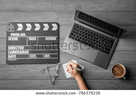 Female scriptwriter working at table, top view