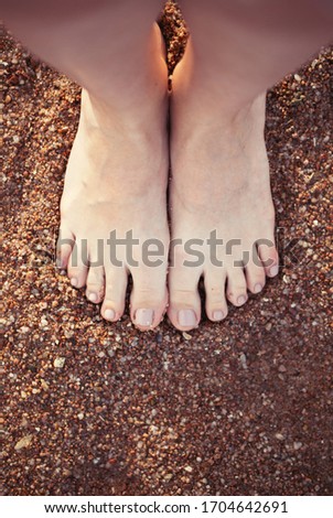 female sea natural style pedicure feet on summer shore sand on sunny beach. meditation yoga at the sea