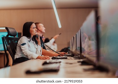 Female Security Guard Operator Talking On The Phone While Working At Workstation With Multiple Displays Security Guards Working On Multiple Monitors