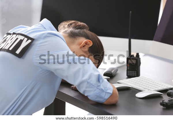 Female security\
guard sleeping at\
workplace