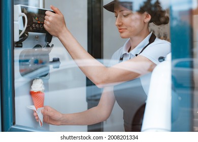 A Female Seller Holds A Cone With A Twisted Ice Cream From A Vending Machine In Her Hand. Small Business And Takeaway Food, Summer Food, Cool Off In The Heat