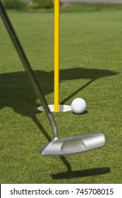 A Female Senior Citizen Practices Her Golf Game On The Putting Green On The Vail Golf Course In Vail, Colorado.  In This Image She Is Lining Up The Putt Close To The Hole.