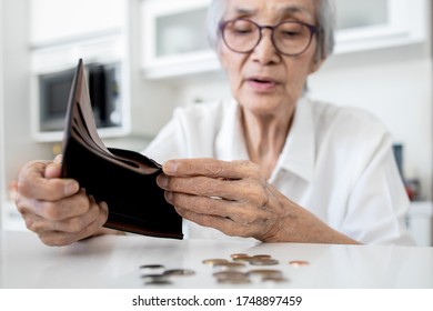 Female Senior Holding Empty Wallet,old People Shaking Out Money Coins In Wallet,financial Problems In The Retirement Age Of Elderly,planning Savings,poverty During Coronavirus Crisis,economic Downturn