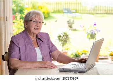 Female Senior Is Using Computer