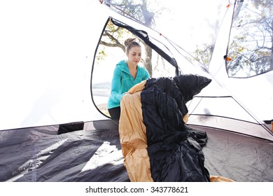 Female Setting Up The Inside Of Her Tent