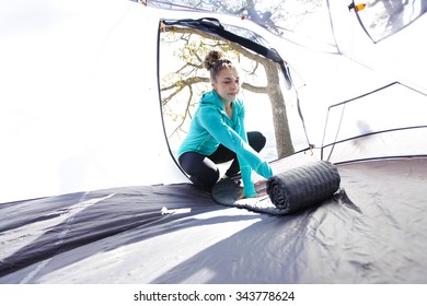 Female Setting Up The Inside Of Her Tent