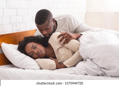 Female Sexual Dysfunction Concept. Woman Ignoring Husband In Bed, Refusing To Make Love.