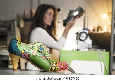 Female Shoe Designer In Background, Custom Made High Heels In Foreground 