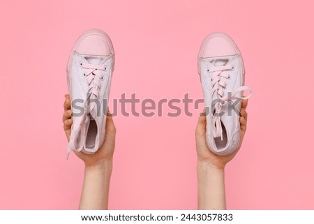 Female shoes with stylish gumshoes on pink background, closeup