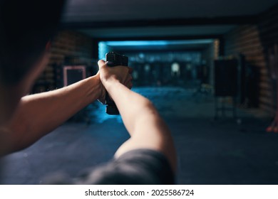 Female Shooter Mastering A Two-handed Hold During The Shooting Drill