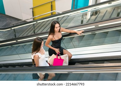 Female Shopaholics On Moving Stairs