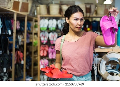 Female Shopper Chooses Beach Flip Flops At A Hardware Store