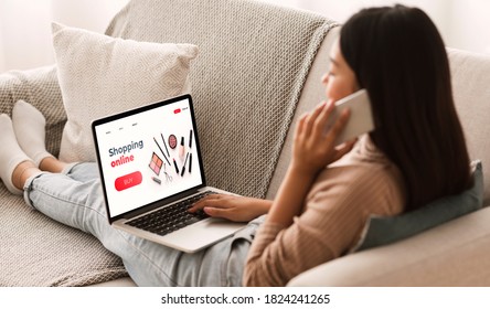 Female Shopping Concept. Back View Of Woman Browsing Online Make Up Store, Talking On Phone, Sitting At Home