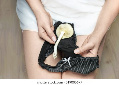 Female Showing Her Underwear With A White Mushroom. Concept Of Candida Infection.