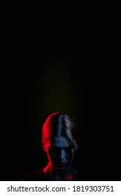 Female Silhouette Portrait. Social Pressure. Exhausted Woman In Neon Light Glow Bowing Head Isolated On Black. Psychology Support. Stuck Problem. Domestic Violence. Toxic Relationship