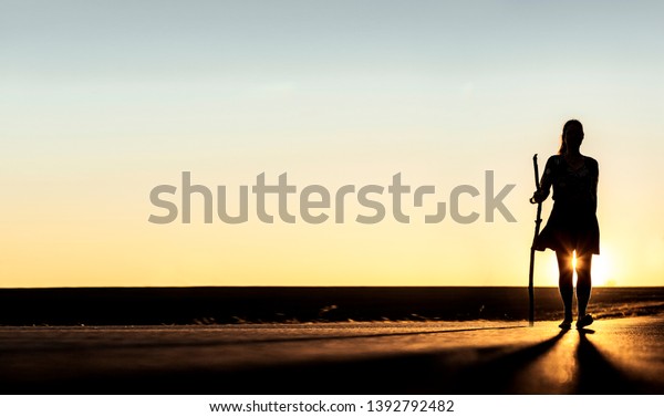 Female silhouette\
Woman with pilgrim\'s\
stick