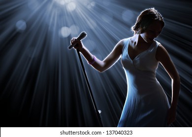 Female Singer On The Stage Holding A Microphone