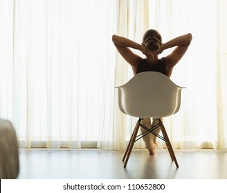 Female sitting in front of window. Rear view - Powered by Shutterstock