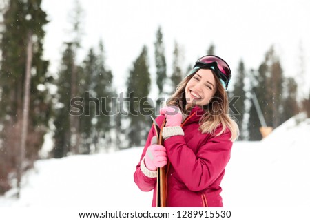Female skier on slope at resort, space for text. Winter vacation
