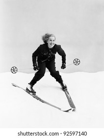 Female skier skiing downhill