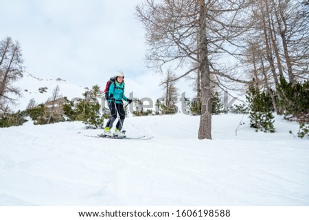 Female skiier enjoying back country skiing in the mountains.