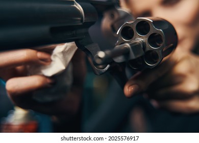 Female Sniper Wiping Her Revolver With A Cloth