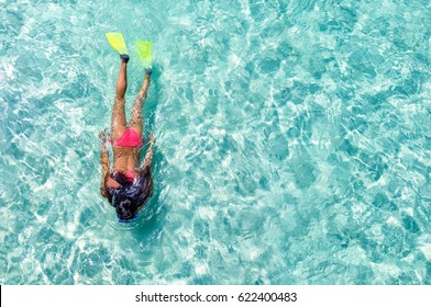 Female snorkeler in turquoise waters - Powered by Shutterstock