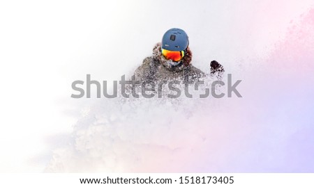 female snowboarder curved and brakes spraying loose deep snow on the freeride slope. downhill with snowboards in fresh snow. freeride world champion. swirls of snow in the air, in a bright mask